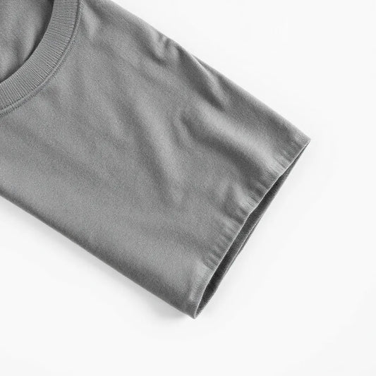 Folded crew-neck t-shirt with visible fabric texture on a clean light background