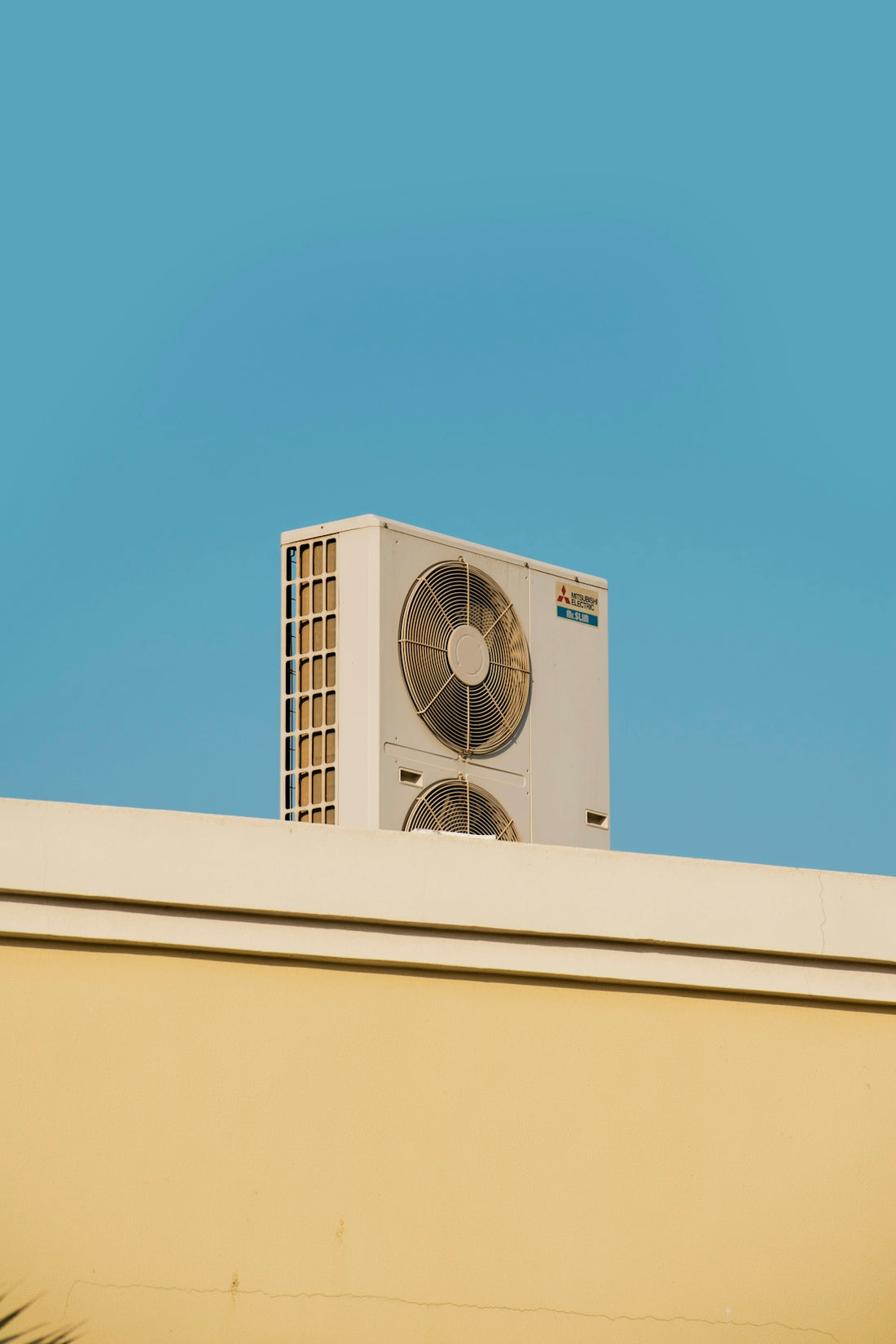 a white air conditioner sitting on top of a building