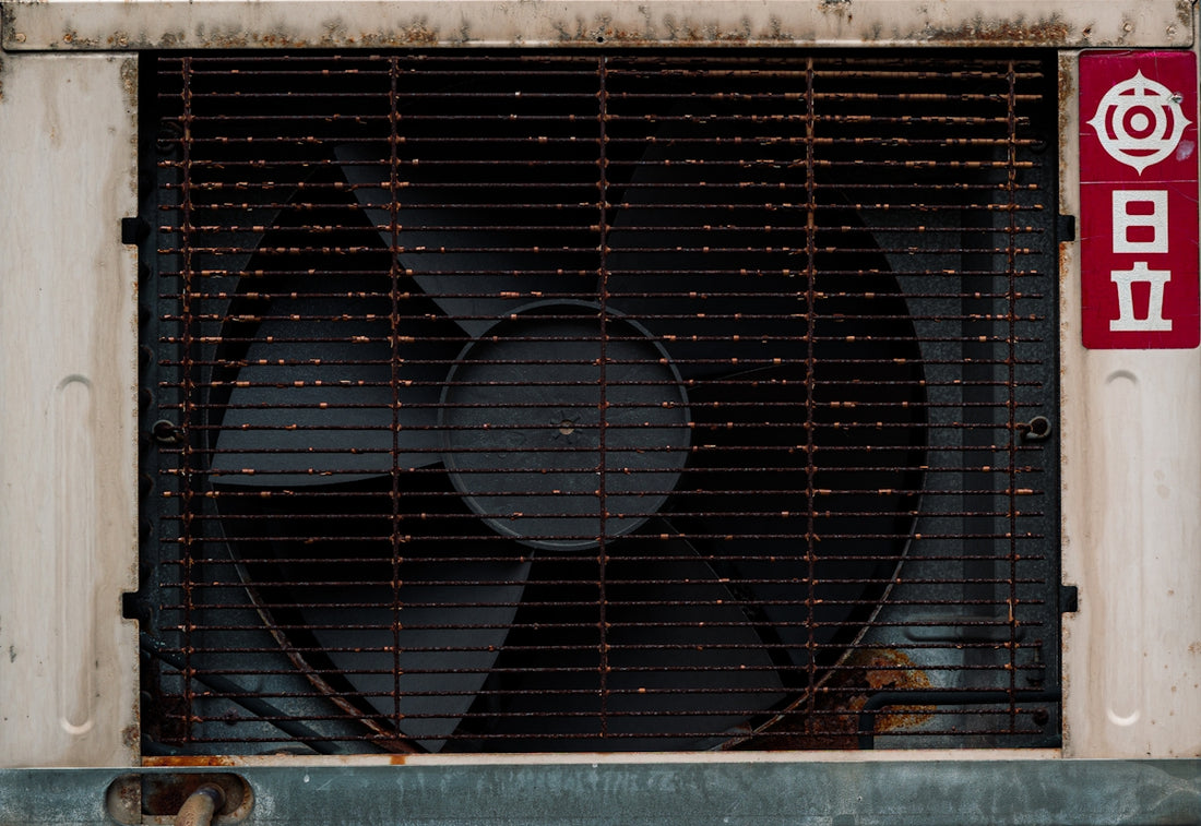 Old rusty fan with japanese writing on the side