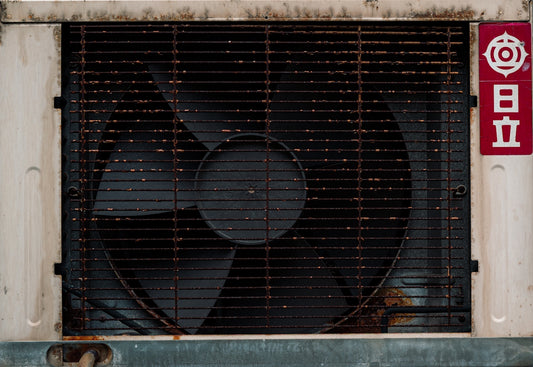 Old rusty fan with japanese writing on the side