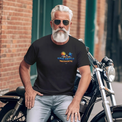 Man sitting on a motorcycle wearing a black t-shirt with a colorful graphic design.