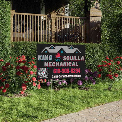 King Squilla Mechanical sign in a garden with flowers and a house in the background
