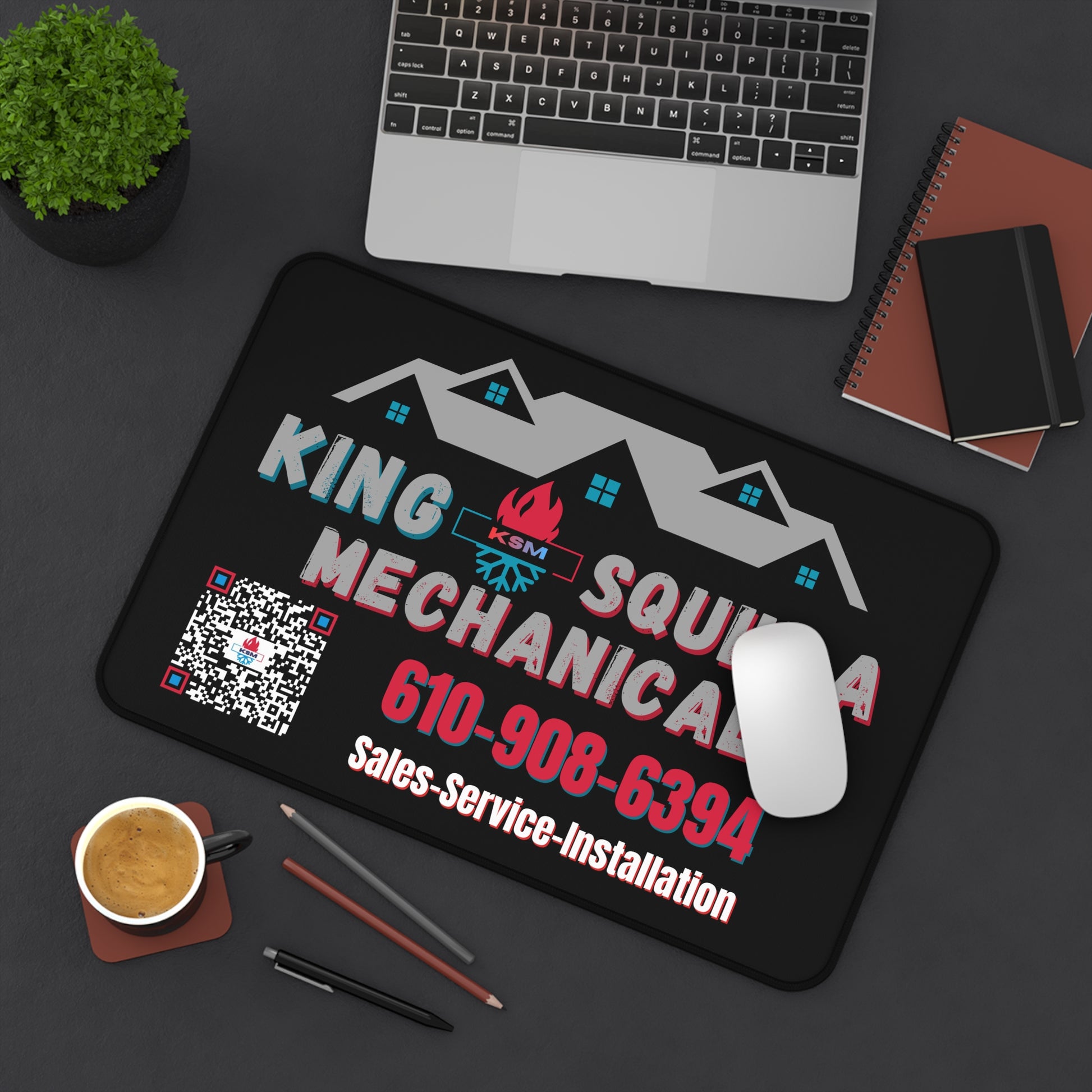King Squid Mechanical mouse pad on a desk with laptop, coffee, and office supplies.
