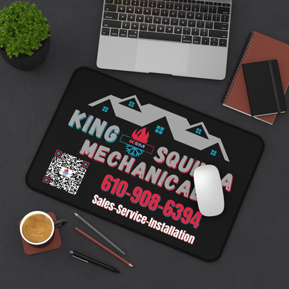 King Squid Mechanical mouse pad on a desk with laptop, coffee, and office supplies.
